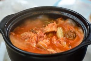 boiling kimchi stew in an earthen pot
