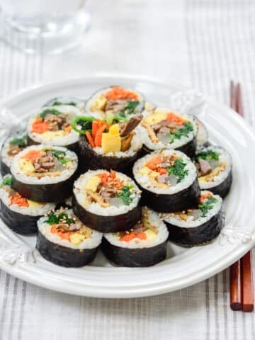 Korean rice rolls sliced and arranged on a plate