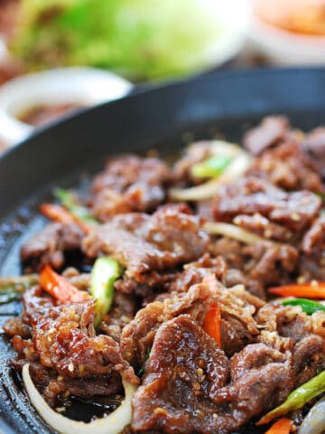 bulgogi cooked on a grill pan with lettuce wraps