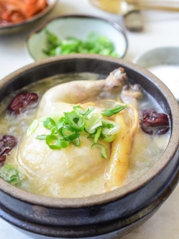 a small whole chicken soup in an earthenware with ginseng